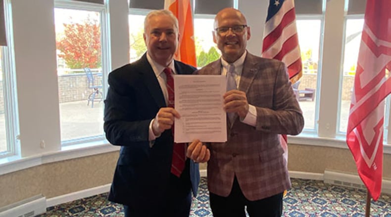 A long-standing partnership serving both Miami University students and the residents of a local senior community has been extended, said school officials. Pictured on left is Timothy McGowan, president of Maple Knolls Communities and Miami President Gregory Crawford at the recent signing ceremony. (Provided)