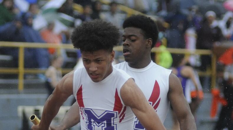 Middletown’s Marquise Petty (right) hands off to teammate Will Thomas in the 800-meter relay during the Division I district track & field meet at Dayton’s Welcome Stadium last May. MARC PENDLETON/STAFF