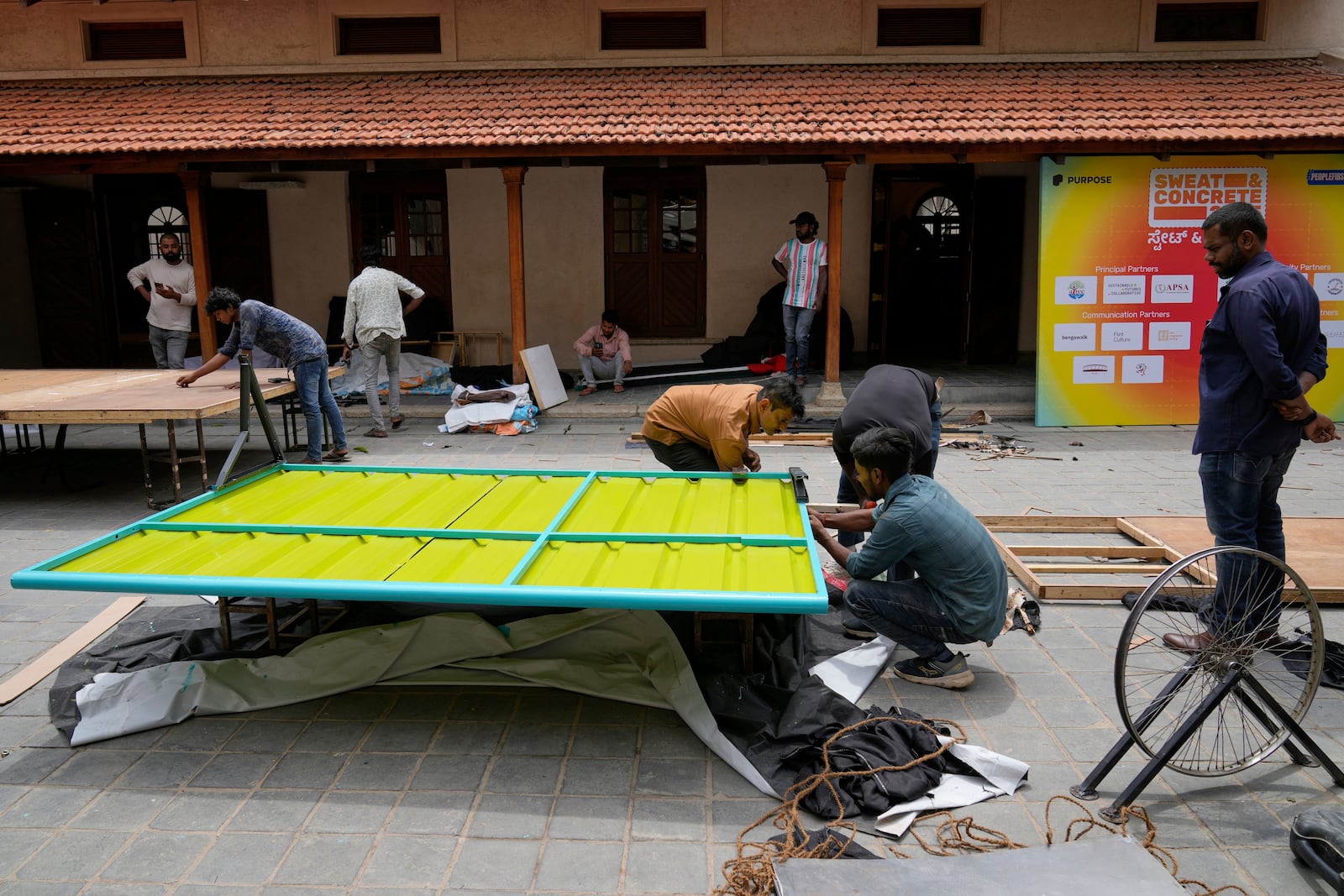 Workers assemble Neralu, an innovative portable heat shelter, before installing it at the Sweat and Concrete 2025 event in Bengaluru, India, Wednesday, May 28, 2025. (AP Photo/Aijaz Rahi)