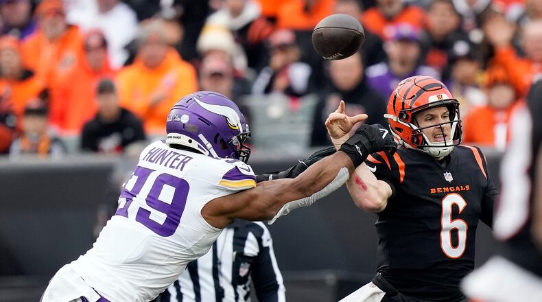 Cincinnati Bengals quarterback Jake Browning (6) throws as he is hit by Minnesota Vikings linebacker Danielle Hunter (99) during the second half of an NFL football game Saturday, Dec. 16, 2023, in Cincinnati. (AP Photo/Carolyn Kaster)