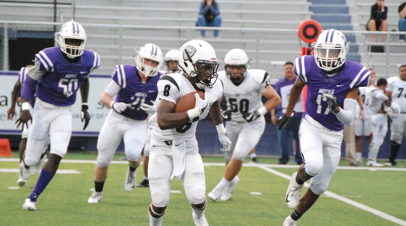 Lakota East’s Donny Wilkinson (8) is chased by Middletown’s Kenny Wilson (17) during Friday night’s game at Barnitz Stadium in Middletown. East won the Greater Miami Conference opener 32-7. CONTRIBUTED PHOTO BY OLIVER SANDERS