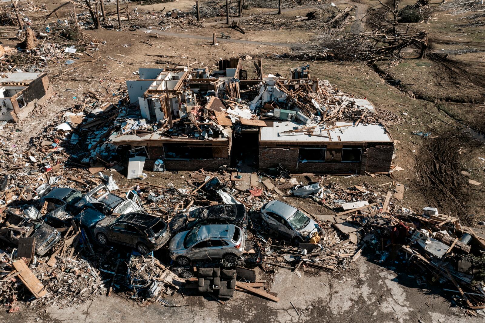 The destroyed Dawson Village Apartments in Dawson Springs, Ky., on Monday, Dec. 13, 2021, where a tornado flattened much of the town on Friday night. Determining how many people died in the tornadoes that ravaged the central U.S. on Friday has been a challenging task so far, with estimates fluctuating as search teams continue to spread out amid vast fields of rubble in an effort to rescue the living and account for the dead. (William Widmer/The New York Times)