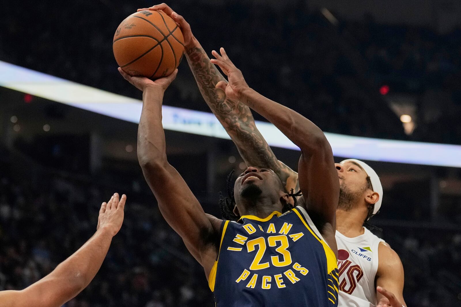 Cleveland Cavaliers forward Chuma Okeke, right, blocks a shot by Indiana Pacers forward Aaron Nesmith (23) in the first half of an NBA basketball game Sunday, April 13, 2025, in Cleveland. (AP Photo/Sue Ogrocki)