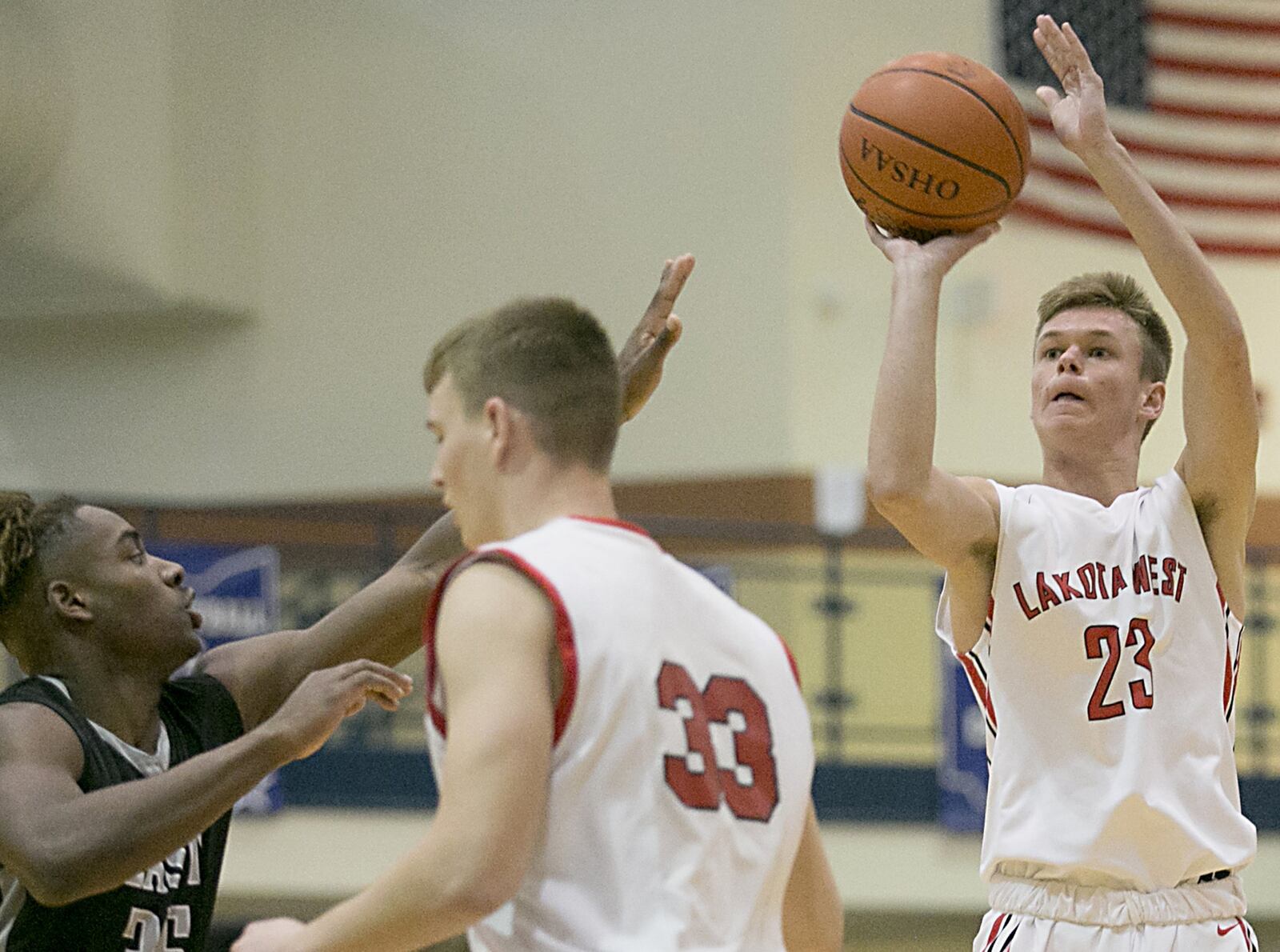 Lakota West forward Matt Oehler shoots over teammate Levi McMonigle (33) of Madison and Lakota East guard Jarrett Cox during the All-Butler County All-Star boys basketball game at the Hamilton Athletic Center on Saturday night. CONTRIBUTED PHOTO BY E.L. HUBBARD
