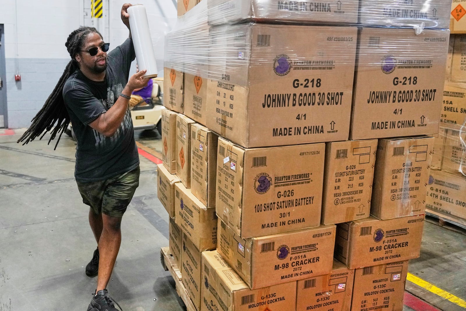 Lamar Teague wraps boxes of fireworks for shipping at the Phantom Fireworks warehouse in Warren, Ohio Wednesday, June 25, 2025. (AP Photo/Sue Ogrocki)