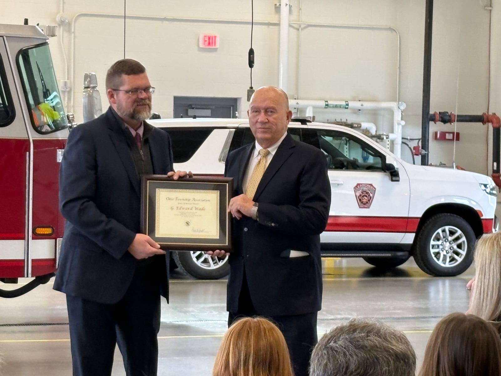 Clearcreek Twp. Trustee Ed Wade, right, is presented with a certificate from the Ohio Township Association in honor of his 48 years in office on Monday, Dec. 22, 2025, by township Administrator Matthew Clark. JEN BALDUF/STAFF