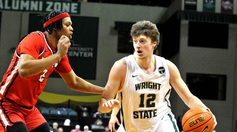 Wright State's AJ Braun, 12, drives past Youngstown States Malek Green, 2, during the first half of a Horizon Conference game at the Nutter Center on Sunday, Dec. 4. DAVID A. MOODIE/CONTRIBUTING PHOTOGRAPHER