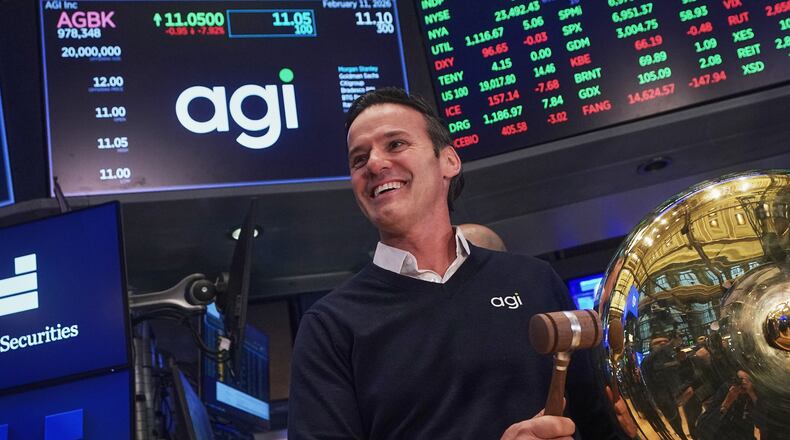 AGI Inc Founder, Executive Chairman & CEO Marciano Testa rings a ceremonial bell on the floor of the New York Stock Exchange as his company's IPO begins trading, Wednesday, Feb. 11, 2026. (AP Photo/Richard Drew)