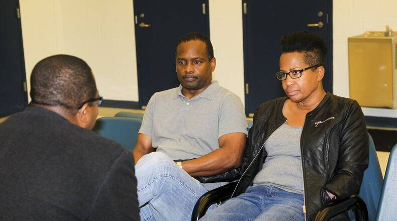 Cleveland and Lisa Cox, along with their attorney, turned themselves in to the Butler County Jail, Friday, Nov. 15, 2013. The couple is accused of abandoning their 9-year-old boy. GREG LYNCH / STAFF