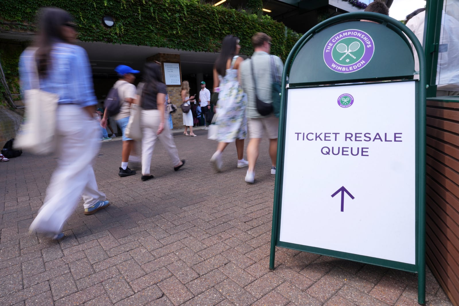 People pickup tickets at a Resale Office during the Wimbledon Tennis Championships in London, Thursday, July 3, 2025.(AP Photo/Kirsty Wigglesworth)