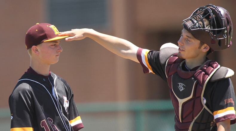 Ross catcher Andrew Beebe (right) consoles pitcher Paul Schroeder during a Division II regional semifinal against Cincinnati Hills Christian Academy on May 24 at Mason. DAVID JABLONSKI/STAFF