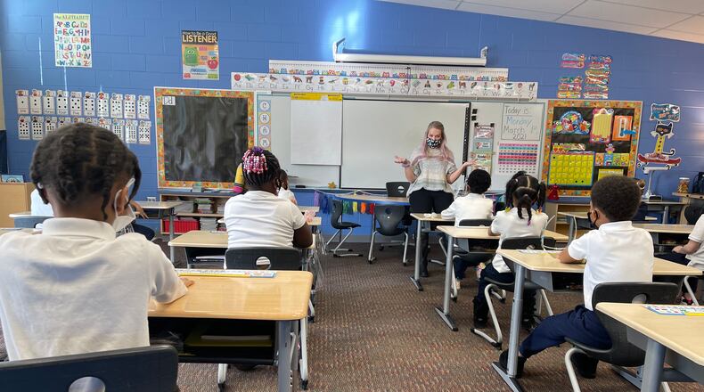 A Fairview Elementary teacher welcomes students back to school and reviews COVID-19 protocols with them before beginning class on March 1. Approximately 75% of Dayton Public Schools students returned for in-person instruction in March, with the rest choosing to stay online. CONTRIBUTED PHOTO