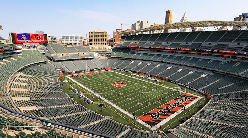 The electronic display shows the team logos over the empty Paul Brown Stadium before an NFL football game between the Cincinnati Bengals and the Minnesota Vikings, Sunday, Sept. 12, 2021, in Cincinnati. (AP Photo/Aaron Doster)