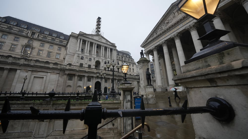 FILE -A man walks in front of the Bank of England, at the financial district in London, Feb. 5, 2026 (AP Photo/Kin Cheung, File)