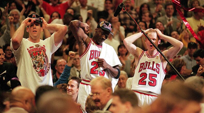 I3 Jun 1997: Michael Jordan #23 of the Chicago Bulls celebrates with teammates Jud Buechler and Steve Kerr #25 after winning game six of the NBA Final against the Utah Jazz at the United Center in Chicago, Illinois. The Bulls defeated the Jazz 90-86.. Mandatory Credit: Jonathan Daniel /Allsport