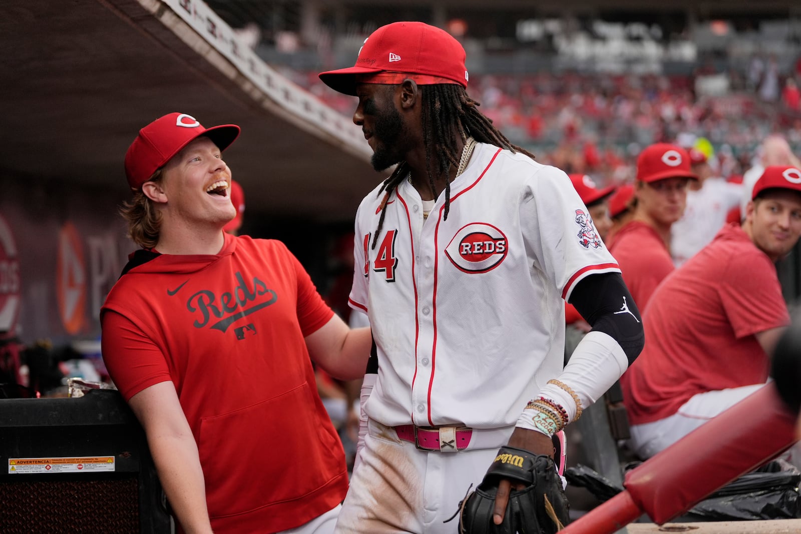 Cincinnati Reds pitcher Andrew Abbott, left, and shortstop Elly De La Cruz celebrate in the dugout as it was announced that Abbott will join De La Cruz as the Reds' representatives for the 2025 Major League Baseball All-Star Game, during the fourth inning of a baseball game against the Miami Marlins in Cincinnati, Tuesday, July 8, 2025. (AP Photo/Carolyn Kaster)