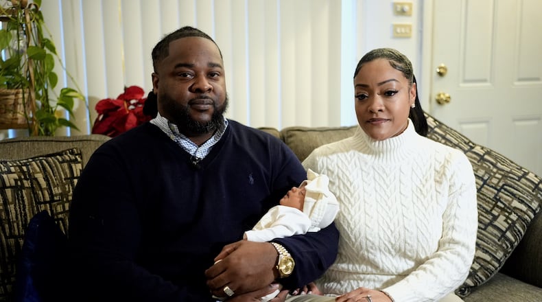 Leon and Mercedes Wells hold their newborn daughter Alena at their home in the Chicago suburb of Dolton, Ill. on Friday, Nov. 28, 2025. (AP Photo/Mark Vancleave)