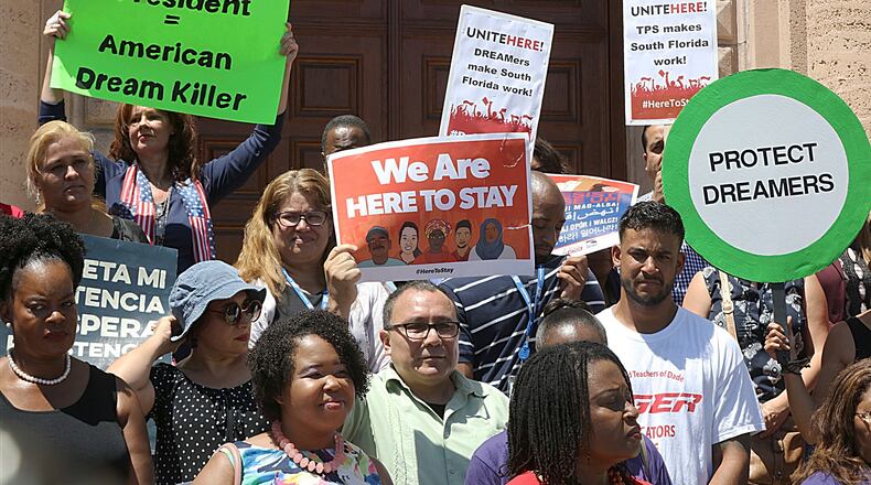 A group attends a rally to defend the Deferred Action for Childhood Arrivals (DACA) program in front of the MDC Freedom Tower in Miami, on Tuesday Sept. 5, 2017. President Donald Trump on Tuesday began dismantling the Deferred Action for Childhood Arrivals, program, the government program protecting hundreds of thousands of young immigrants who were brought into the country illegally as children. (Pedro Portal/Miami Herald via AP)