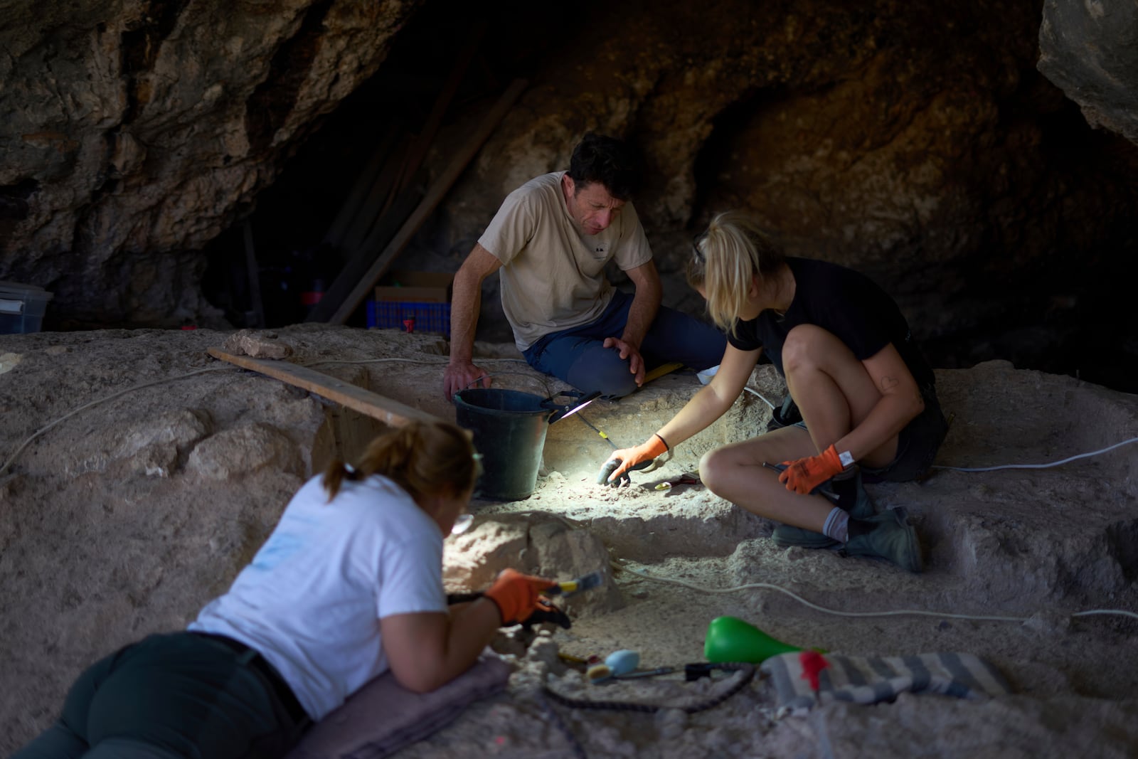 Professor of Archaeology Yossi Zaidner works in Tinshemet Cave, where archaeologists are excavating one of the world's oldest known burial sites, dating back 100,000 years, near Shoam, Israel, Tuesday, July 15, 2025. (AP Photo/Ariel Schalit)