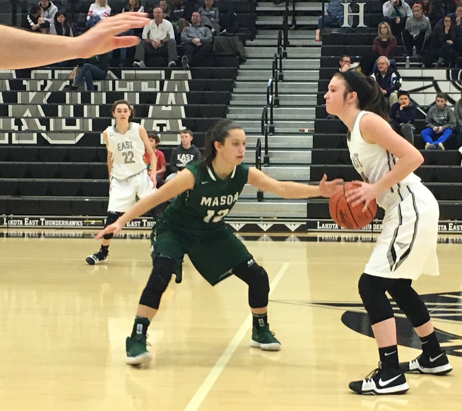 Mason’s Megan Wagner gets close to Lakota East’s Lily Rupp as an official begins to count Wednesday night at East. RICK CASSANO/STAFF