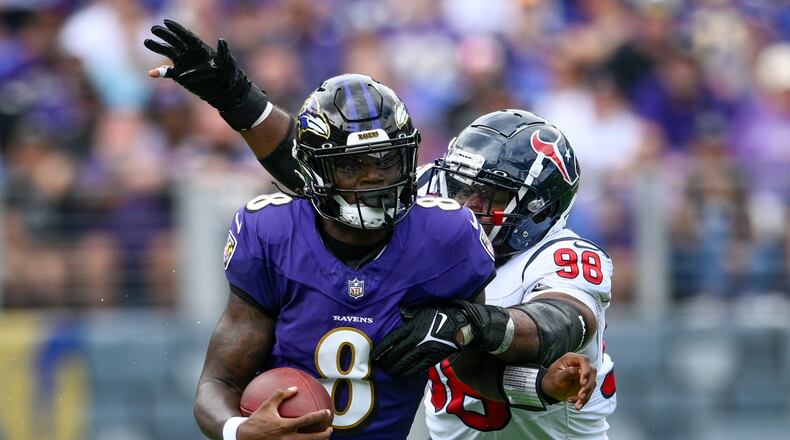 Baltimore Ravens' Lamar Jackson runs past Houston Texans' Sheldon Rankins during the first half of an NFL football game Sunday, Sept. 10, 2023, in Baltimore. (AP Photo/Nick Wass)