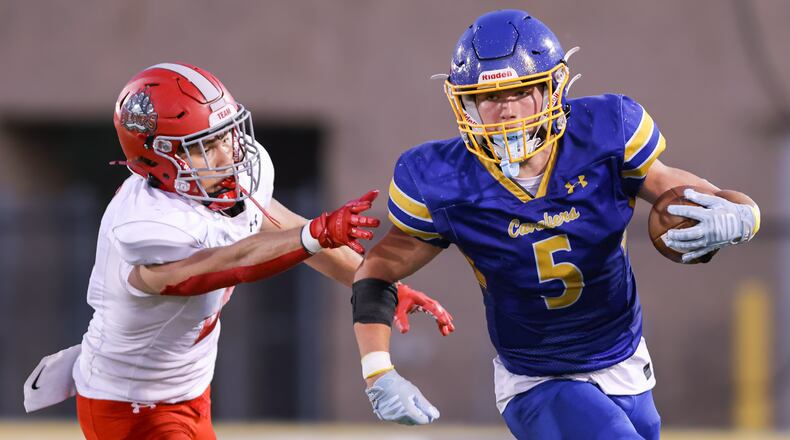 Lehman Catholic senior receiver Evan O'Leary runs with pressure from Northridge's Dylan Truesdale during a Three Rivers Conference game on Thursday, Sept. 11 at Sidney Memorial Stadium. BRYANT BILLING / STAFF