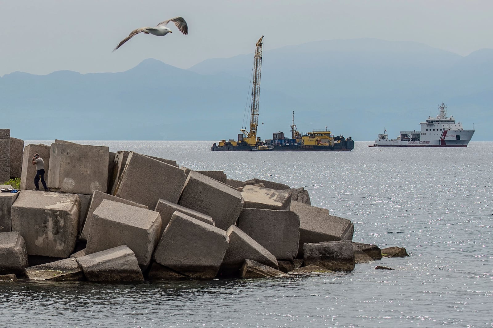 Italian Coast Guard's Luigi Dattilo CP940 patrol vessel, right, assists the multi-purpose floating work barge Hebo Lift 2 monitoring the stretch of sea off Porticello, near Palermo, Sicily, Italy, Sunday, May 4, 2025, where the British superyacht Bayesian sunk on August 19, 2024 as the operations for its recovery start. (AP Photo/Salvatore Cavalli)
