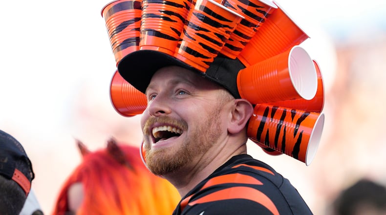 A Cincinnati Bengals fan smiles as his team leads the Carolina Panthers during the second half of an NFL football game, Sunday, Nov. 6, 2022, in Cincinnati. (AP Photo/Jeff Dean)