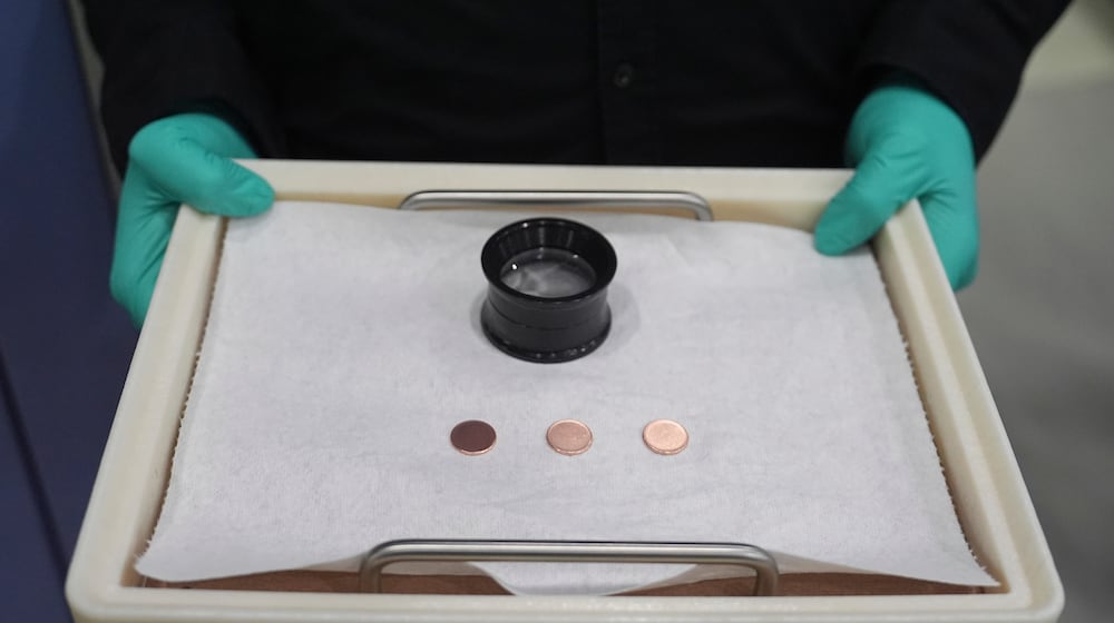 FILE - Blank coins wait to be the last pennies pressed at the U.S. Mint, in Philadelphia, Nov. 12, 2025. (AP Photo/Matt Slocum, File)