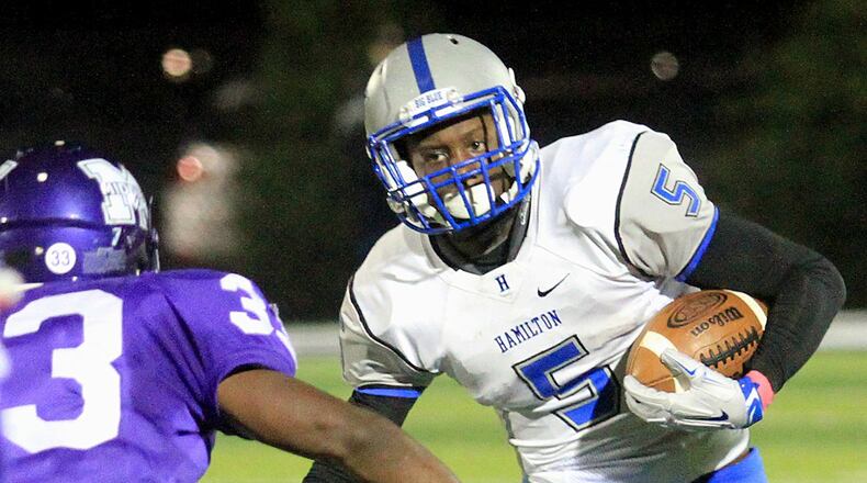 Hamilton running back Isaiah Murph tries to avoid Middletown defensive back Marquise Petty during a Greater Miami Conference game at Barnitz Stadium in Middletown on Oct. 9, 2015. Murph will be one of the local players competing in the Southwestern Ohio Football Coaches Association’s Ron Woyan East-West All-Star Game on Thursday night at Kings. CONTRIBUTED PHOTO BY E.L. HUBBARD