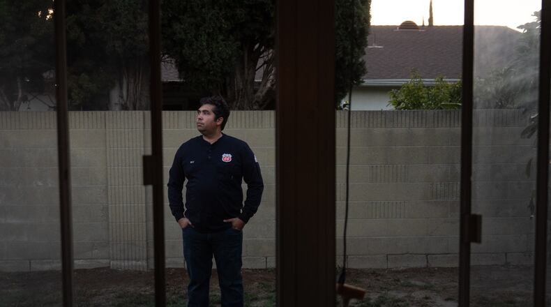 Wilfredo Cruz, an oil worker at the Phillips 66 Los Angeles Refinery Wilmington Plant, stands for a photo in the backyard of his home in Cerritos, Calif., Tuesday, Sept. 30, 2025. (AP Photo/Jae C. Hong)