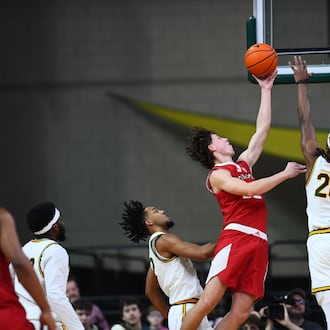 Miami’s Brant Byers goes up to the basket as Wright State’s Andrea Holden contests the shot on Tuesday at the Nutter Center. KYLE HENDRIX / CONTRIBUTED