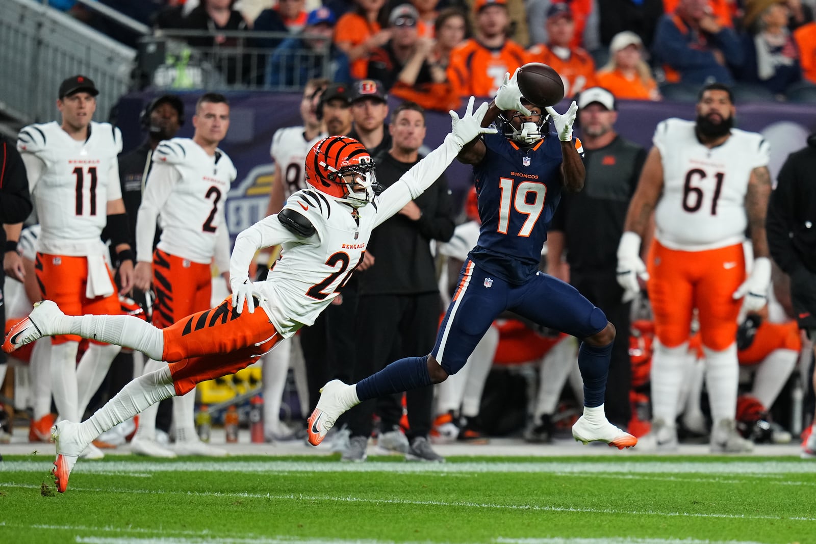 Denver Broncos wide receiver Marvin Mims Jr. (19) catches a pass against Cincinnati Bengals cornerback Marco Wilson (24) during the first half of an NFL football game Monday, Sept. 29, 2025, in Denver. (AP Photo/Jack Dempsey)