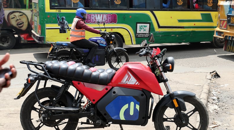 A man rides an electric Spiro motorcycle in Nairobi, Kenya, Tuesday, Feb. 24, 2026. (AP Photo/Henry Naminde)