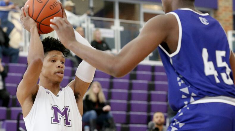 Middletown guard Kei’Aunte Powell is defended by Jo Smith of Crestwood Prep (Canada) on Sunday during the inaugural Midwest King Classic at Wade E. Miller Arena in Middletown. Crestwood won 64-50. CONTRIBUTED PHOTO BY E.L. HUBBARD