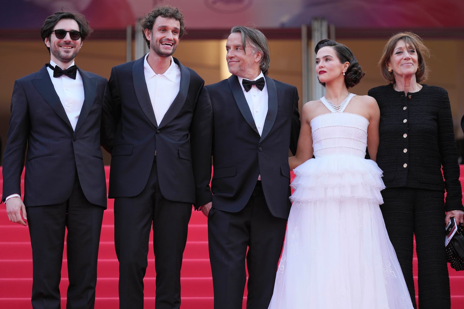 Guillaume Marbeck, from left, Aubry Dullin, director Richard Linklater, Zoey Deutch and Michele Halberstadt pose for photographers upon arrival at the premiere of the film 'Nouvelle Vague' at the 78th international film festival, Cannes, southern France, Saturday, May 17, 2025. (AP Photo/Natacha Pisarenko)