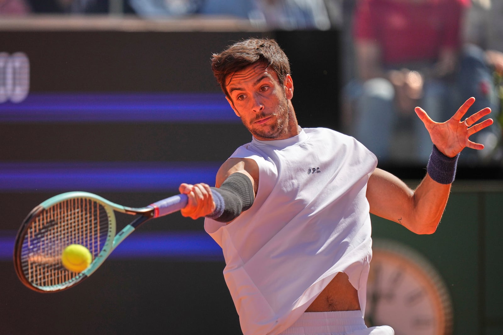 Italy's Lorenzo Musetti returns the ball to Spain's Carlos Alcaraz during their semifinal tennis match at the Italian Open, at the Foro Italico, in Rome, Friday, May 16, 2025. (AP Photo/Andrew Medichini)