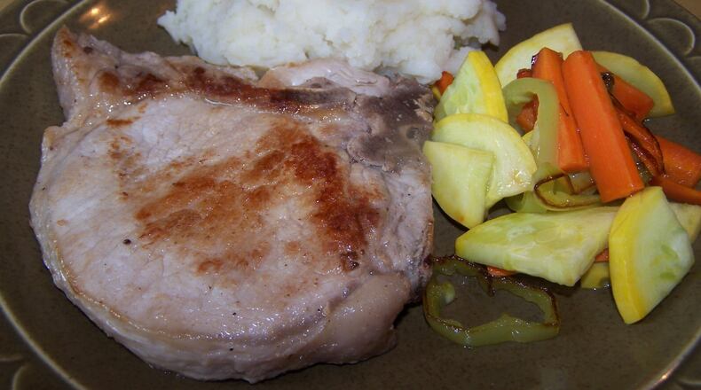 Frequent brushing with a cider vinegar-based sauce is what makes Preble County Pork Festival pork chops stand out. (Contributed photo by Rebecca Sodergren)