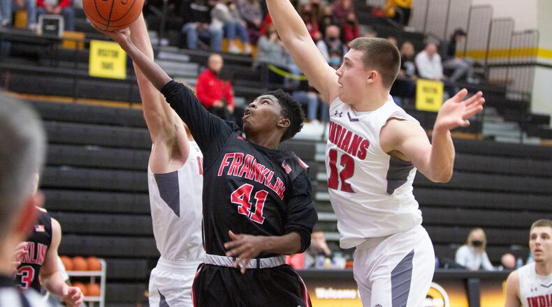 Franklin's Tez Lattimore tries to score against Stebbins' Nate Keller in a Division I sectional game Saturday at Centerville. Franklin advanced with a 71-65 victory. Jeff Gilbert/CONTRIBUTED