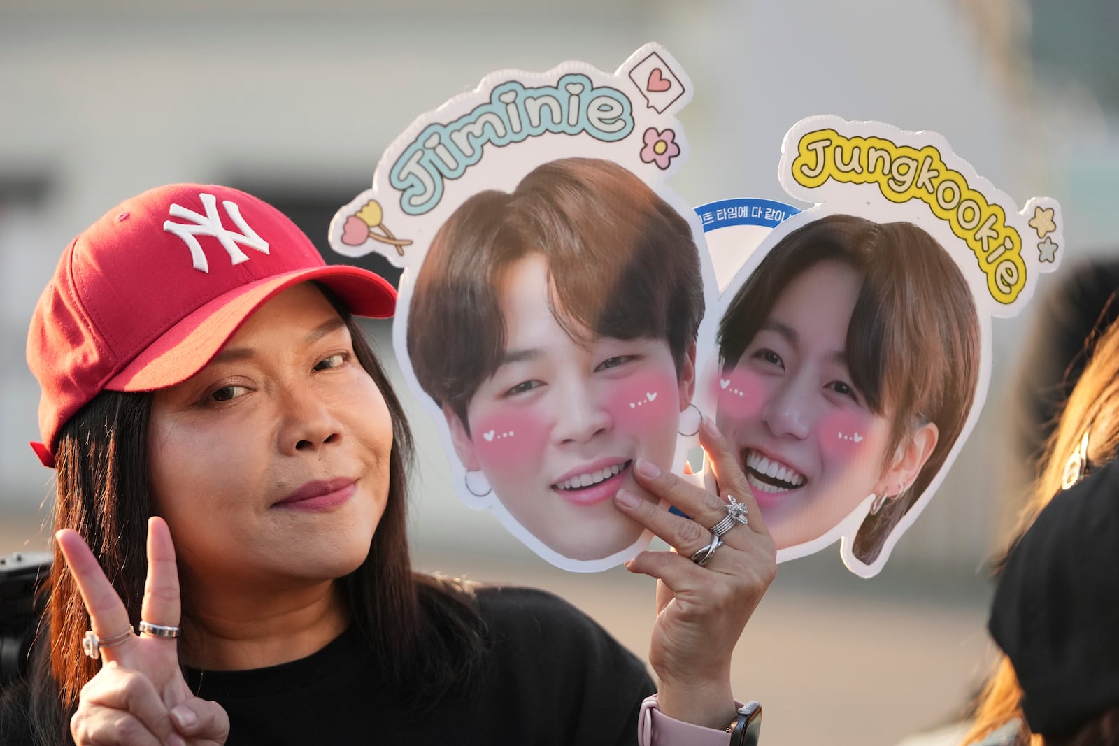 A fan from Thailand waits for arrival of K-pop band BTS members Jimin and Jung Kook in Yeoncheon, South Korea, Wednesday, June 11, 2025. (AP Photo/Lee Jin-man)