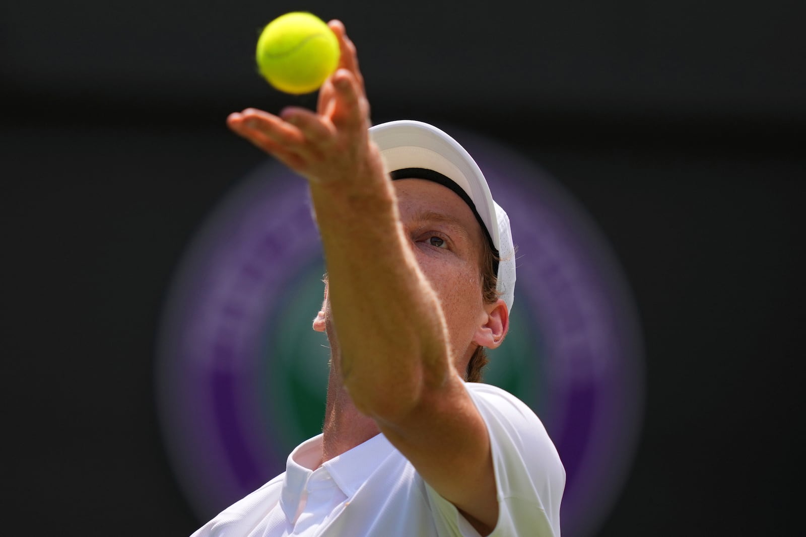 Jannik Sinner of Italyserves the ball to Luca Nardi of Italy during their first round men's singles match at the Wimbledon Tennis Championships in London, Tuesday, July 1, 2025.(AP Photo/Kirsty Wigglesworth)