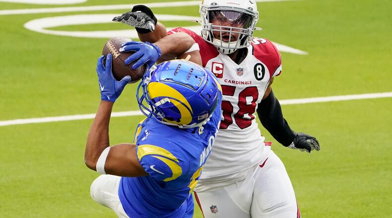 Los Angeles Rams wide receiver Robert Woods, left, catches a pass against Arizona Cardinals middle linebacker Jordan Hicks (58) during the first half of an NFL football game in Inglewood, Calif., Sunday, Jan. 3, 2021. (AP Photo/Jae C. Hong)