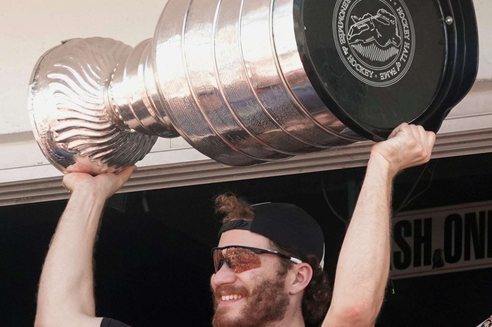 Florida Panthers' Matthew Tkachuk holds up the Stanley Cup during the team's celebration, Wednesday, June 18, 2025, at the Elbo Room in Fort Lauderdale, Fla. The dent on the cup is clearly visible near his left hand. (Joe Cavaretta/South Florida Sun-Sentinel via AP)