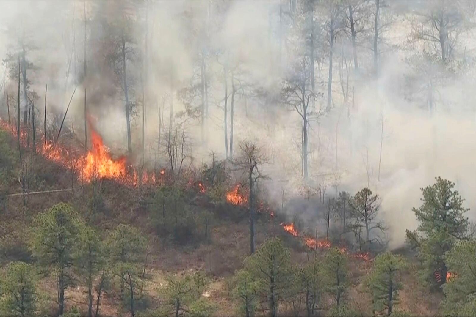 In this image taken from aerial video shows smoke and flames from wildfires in Ocean County, N.J., Wednesday, April 23, 2025. (WPVI via AP)