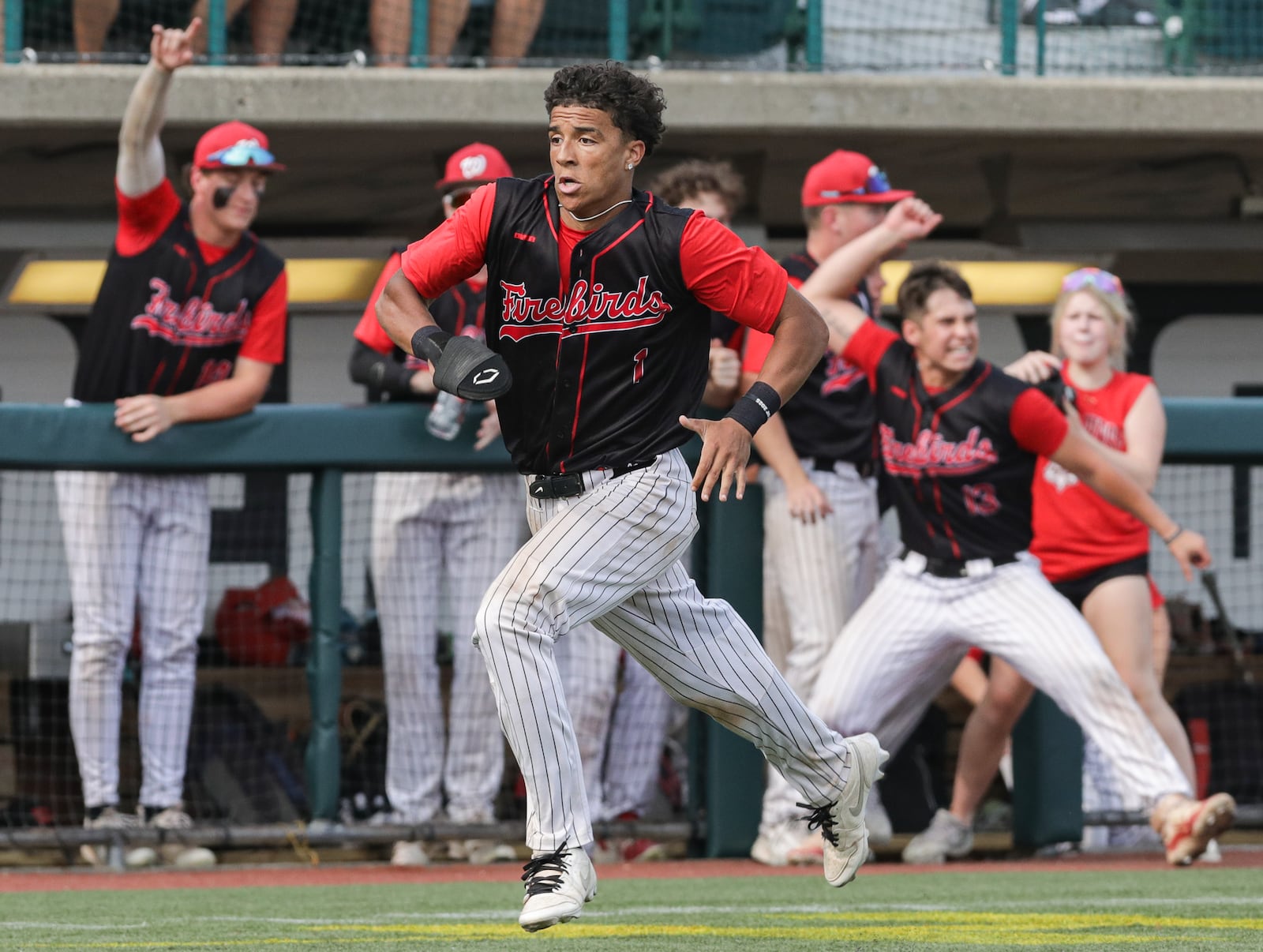 Lakota West senior outfielder Isaiah Meade-Moss races home as teammates in the dugout cheer during the second inning of a Division I regional final against Cincinnati Moeller on Wednesday at Wright State University's Nischwitz Stadium. BRYANT BILLING / STAFF