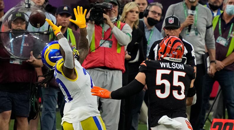 Los Angeles Rams running back Darrell Henderson Jr. (27) misses the catch against Cincinnati Bengals inside linebacker Logan Wilson (55) during the first half of the NFL Super Bowl 56 football game Sunday, Feb. 13, 2022, in Inglewood, Calif. (AP Photo/Julio Cortez)
