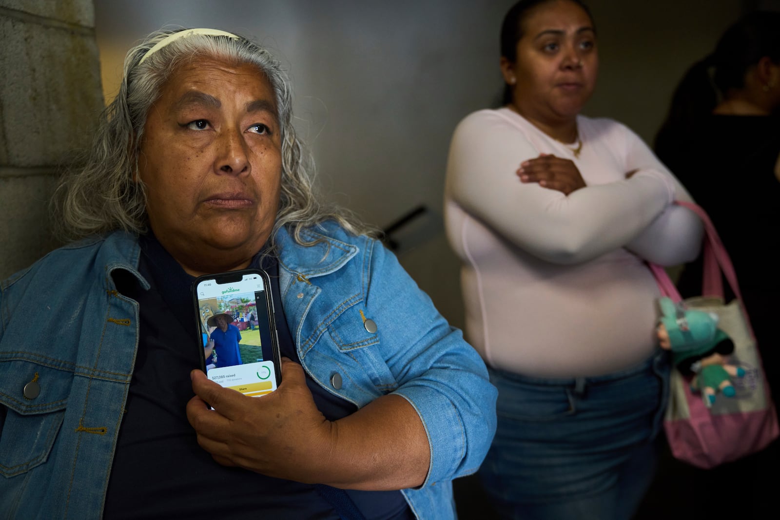 Anita Neri Lozano holds a picture of her detained husband, Ambrosio Enrique Lozano, an ice-cream vendor detained in Culver City, Calif., as she stands outside the ICE Los Angeles Staging Facility looking to visit him in Los Angeles, on Wednesday, June 25, 2025. (AP Photo/Damian Dovarganes)