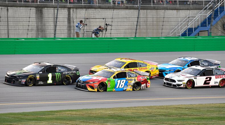 Kurt Busch (1) leads Kyle Busch (18), Joey Logano (22), Brad Keselowski (2) and Martin Truex Jr. (19) following a restart during the NASCAR Cup Series auto race at Kentucky Speedway in Sparta, Ky., Saturday, July 13, 2019. (AP Photo/Timothy D. Easley)