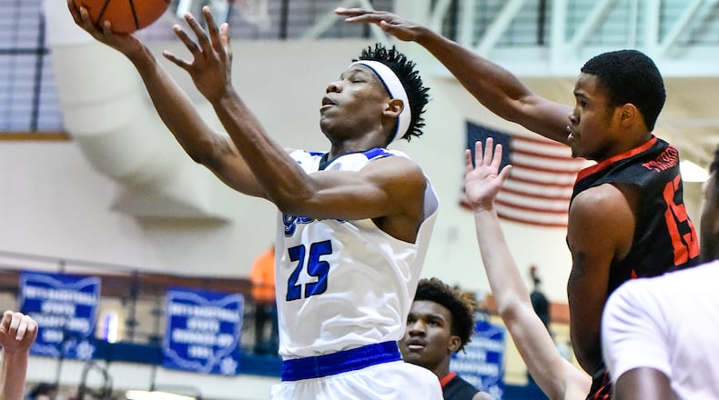 Lakota West’s Myles Greenwood tries to defend a shot by Hamilton’s D’Marco Howard during their game Jan. 5 at the Hamilton Athletic Center. Big Blue defeated the visiting Firebirds 60-34. NICK GRAHAM/STAFF