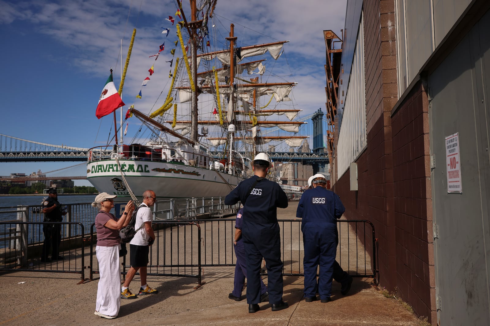 United States Coast Guardsmen arrive at Pier 35, Sunday, May 18, 2025 in New York, where the Cuauhtémoc, a masted Mexican Navy training ship that collided with the Brooklyn Bridge the night before, sits docked. (AP Photo/Yuki Iwamura)